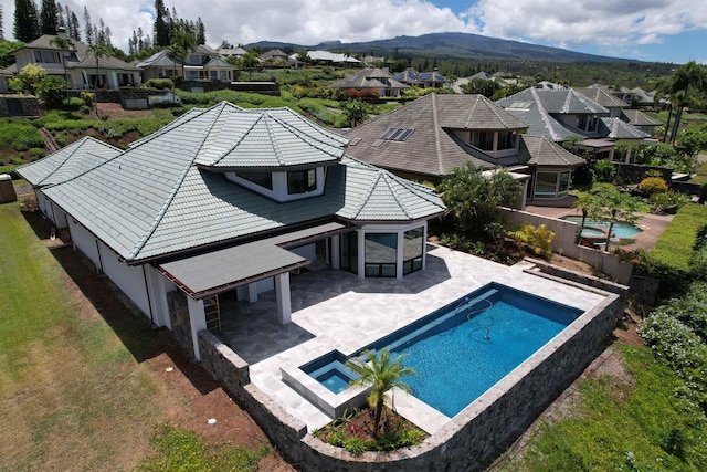 view of pool with a mountain view, a yard, and a patio area