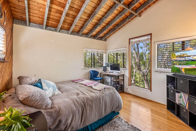 bedroom with wood ceiling, lofted ceiling with beams, and hardwood / wood-style flooring