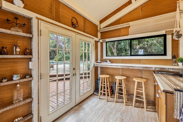 doorway to outside with french doors, bar, and lofted ceiling