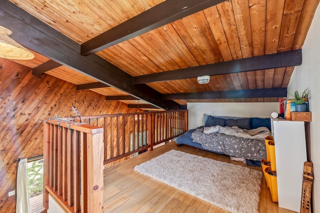 bedroom featuring wood ceiling, wood walls, hardwood / wood-style flooring, and vaulted ceiling with beams