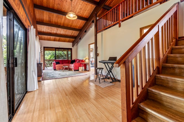 foyer featuring vaulted ceiling with beams, wooden ceiling, and light hardwood / wood-style floors