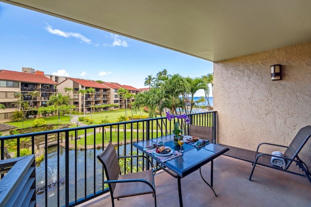 balcony featuring a water view