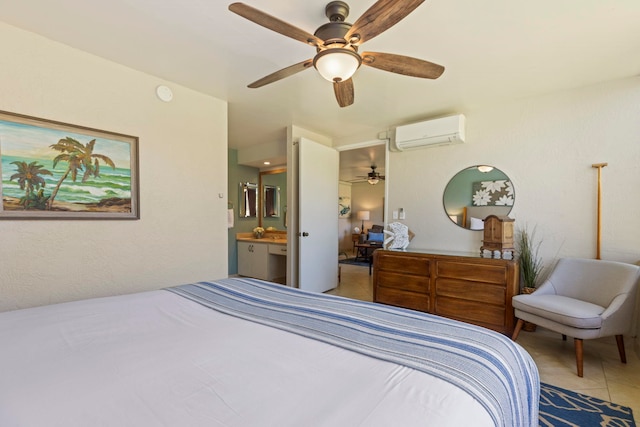 tiled bedroom with a wall mounted air conditioner, ensuite bathroom, and ceiling fan