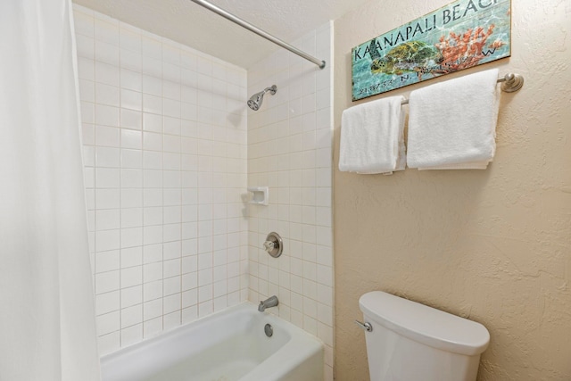 bathroom featuring shower / bath combo and toilet