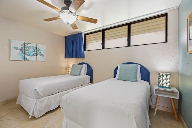 tiled bedroom with ceiling fan