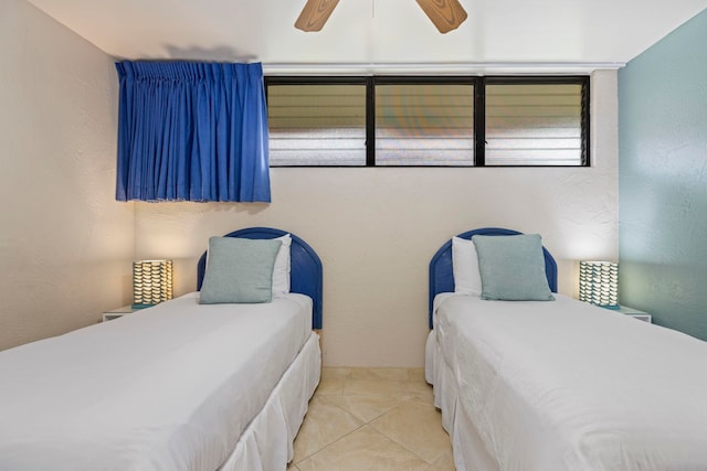 bedroom with ceiling fan and light tile patterned floors