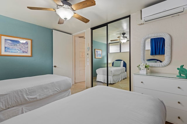 tiled bedroom with a wall mounted air conditioner and ceiling fan