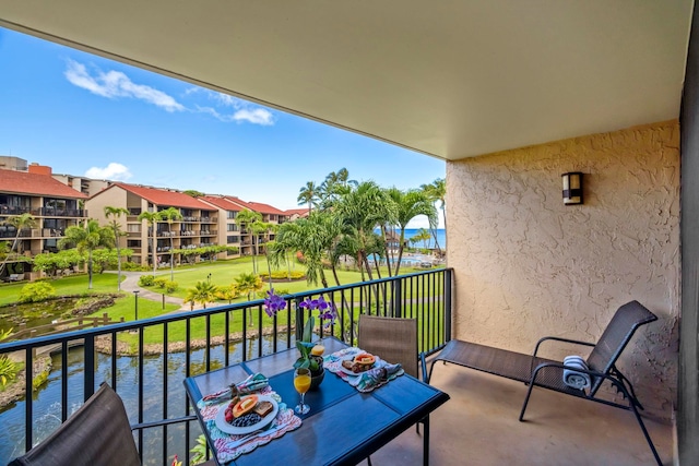 balcony featuring a water view