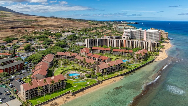 drone / aerial view featuring a water view and a view of the beach