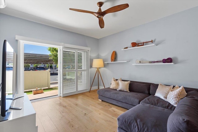 living room with hardwood / wood-style floors and a ceiling fan