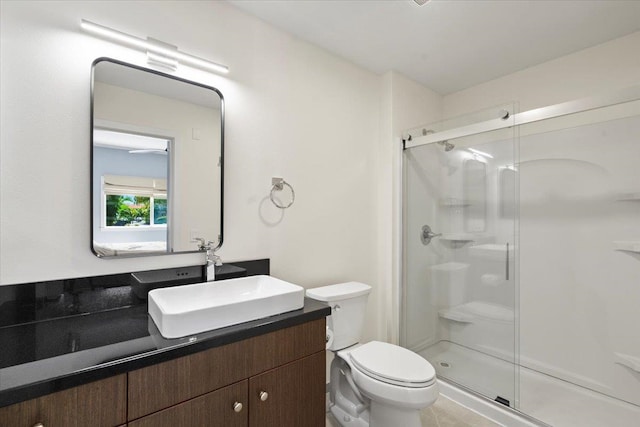 full bath with vanity, toilet, and a shower stall