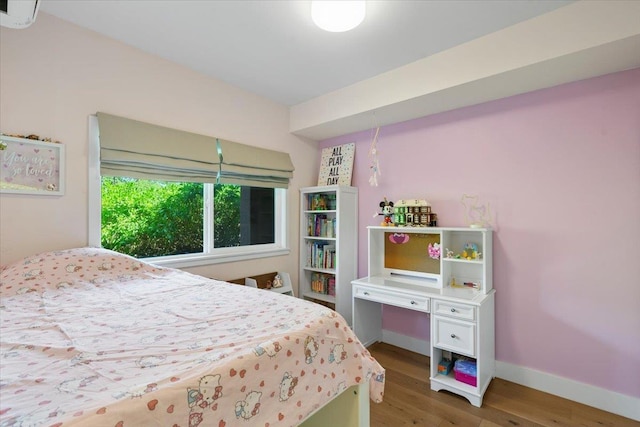 bedroom featuring baseboards and wood finished floors