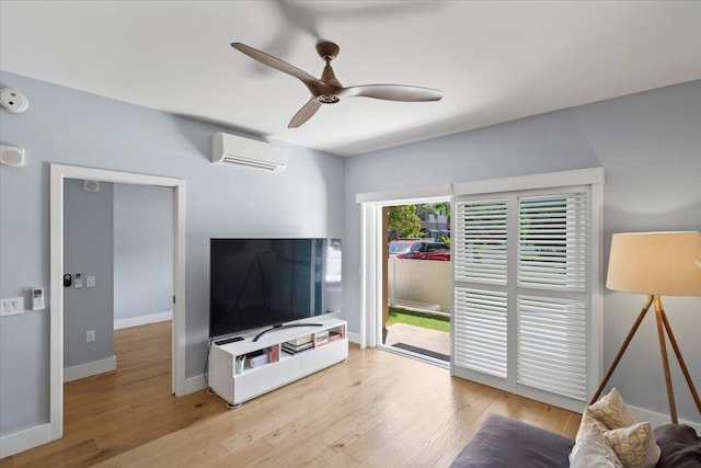 living room featuring wood finished floors, baseboards, a wall mounted air conditioner, and ceiling fan