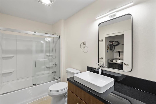 bathroom featuring visible vents, toilet, vanity, and bath / shower combo with glass door