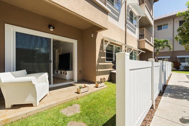 exterior space featuring stucco siding and fence