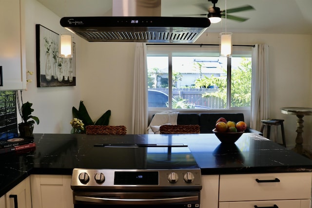 kitchen with stainless steel electric range oven, dark countertops, exhaust hood, and white cabinetry