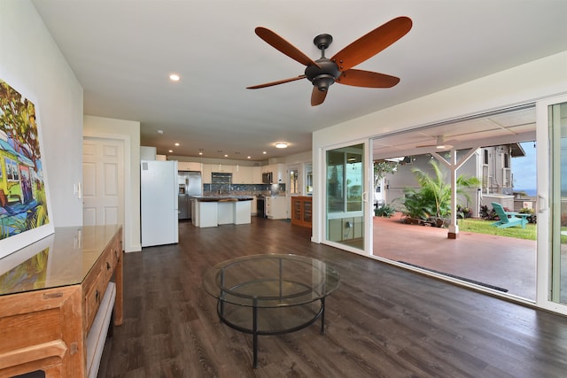 living room featuring dark hardwood / wood-style floors and ceiling fan