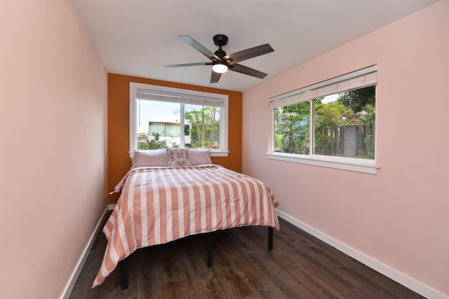 bedroom with ceiling fan and dark hardwood / wood-style floors