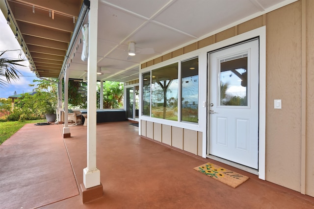 property entrance with ceiling fan and a patio area