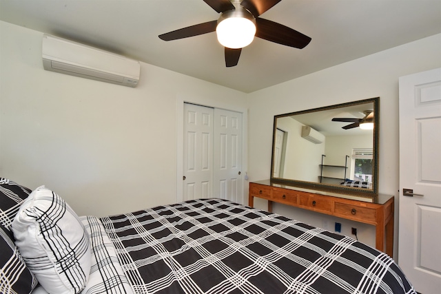 bedroom featuring an AC wall unit, ceiling fan, and a closet