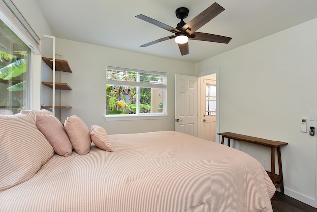 bedroom with dark wood-type flooring and ceiling fan