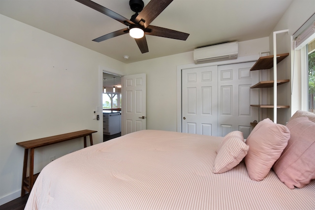 bedroom with a wall mounted AC, multiple windows, and a closet