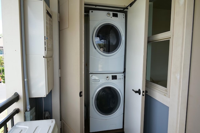 washroom featuring stacked washing maching and dryer