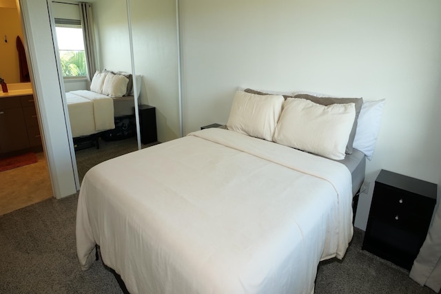 carpeted bedroom featuring a closet