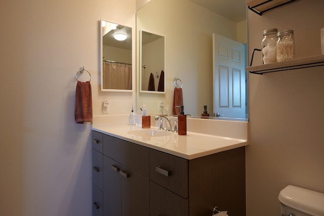 bathroom featuring vanity and toilet