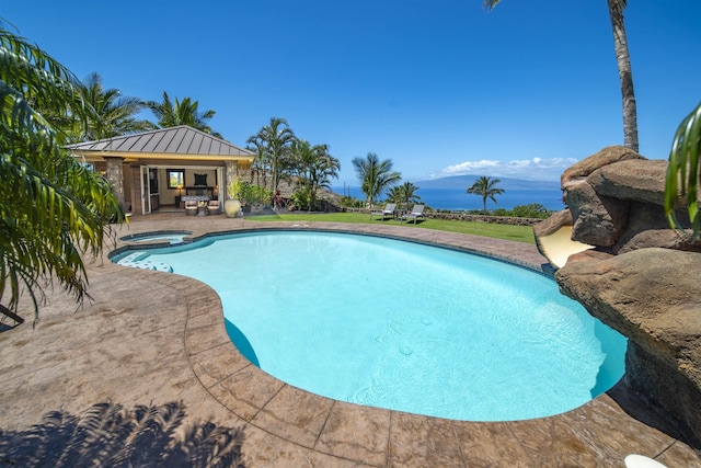 view of swimming pool with a pool with connected hot tub and a patio