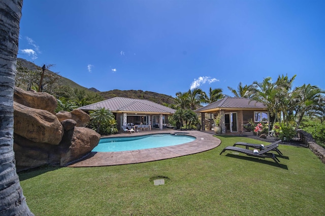 outdoor pool featuring a yard and a patio area