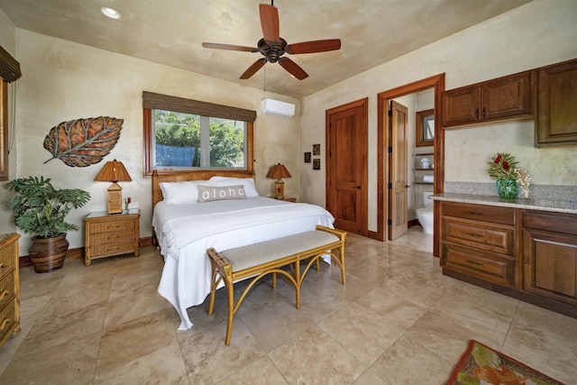 bedroom with ensuite bath, a ceiling fan, and a wall mounted AC