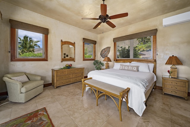 bedroom featuring a wall mounted air conditioner, baseboards, and ceiling fan