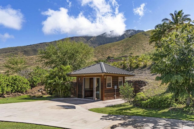 view of property's community with an outdoor structure and a mountain view