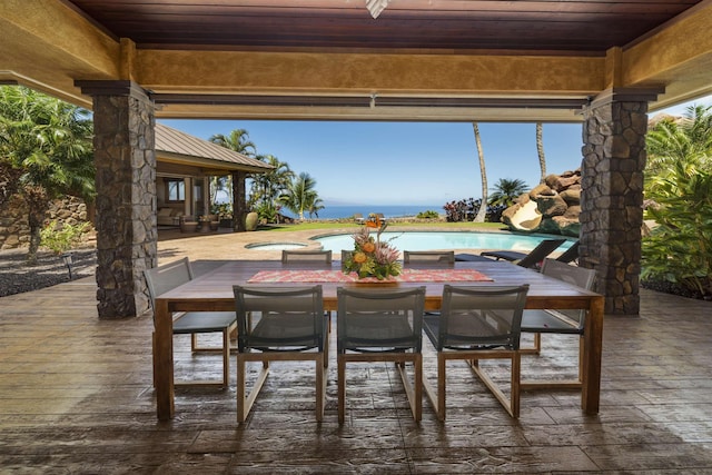 view of patio with an outdoor pool, outdoor dining area, and a deck