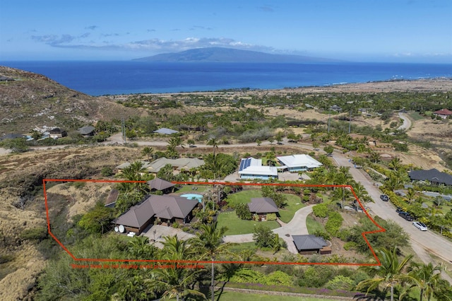 drone / aerial view featuring a water and mountain view