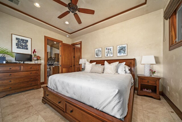 bedroom featuring light tile patterned floors, visible vents, baseboards, and a raised ceiling