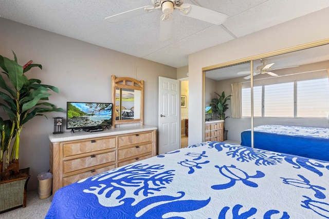 bedroom featuring ceiling fan, a closet, and carpet