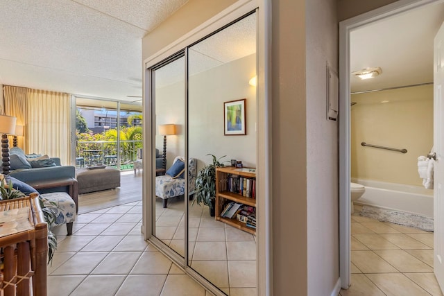 interior space featuring light tile patterned floors and a textured ceiling