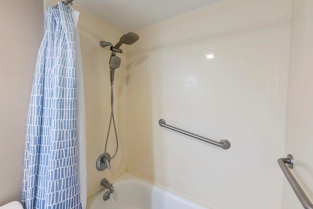 bathroom with shower / bath combination with curtain