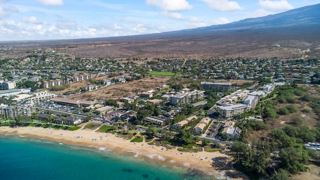 birds eye view of property featuring a view of the beach and a water and mountain view