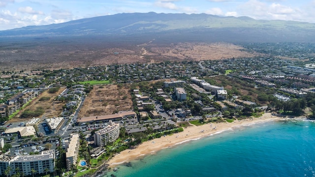 aerial view featuring a water and mountain view and a beach view