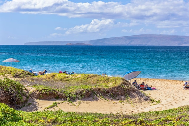 water view with a mountain view and a view of the beach