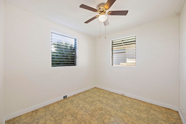 empty room with ceiling fan and a healthy amount of sunlight