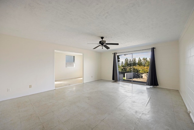 spare room with ceiling fan and a textured ceiling