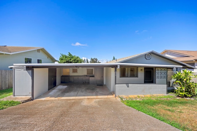 view of front of property featuring a carport and a front lawn