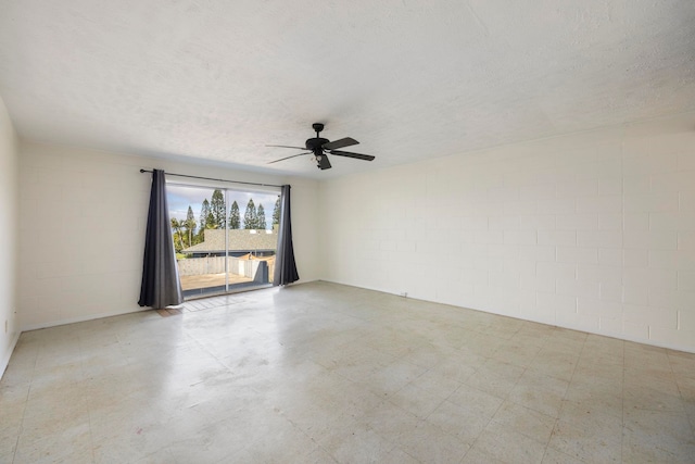 empty room featuring ceiling fan and a textured ceiling