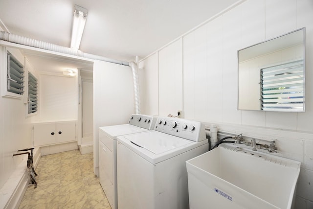 washroom featuring washing machine and clothes dryer and sink