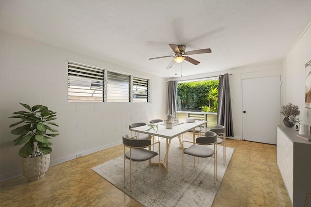 dining space featuring a textured ceiling and ceiling fan