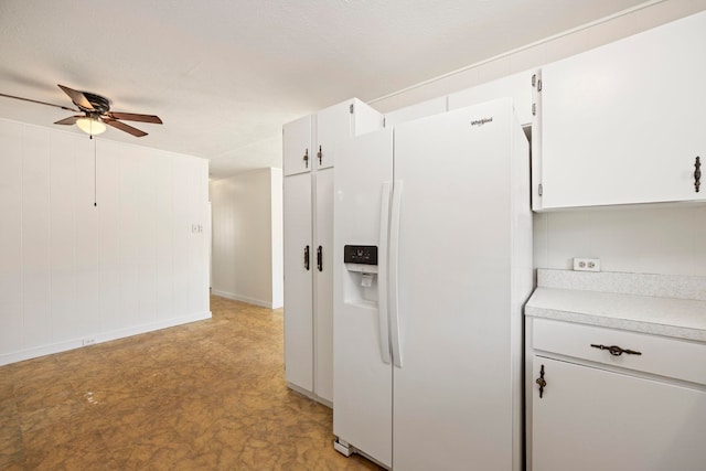 kitchen with white cabinets, ceiling fan, white refrigerator with ice dispenser, and light carpet